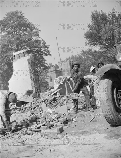 Washington, D.C. Loading debris from wrecked buildings along Independence Avenue.