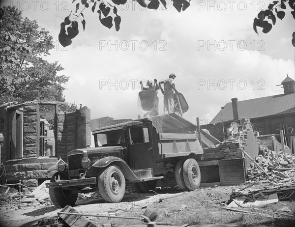 Washington, D.C. Loading debris from wrecked buildings along Independence Avenue.