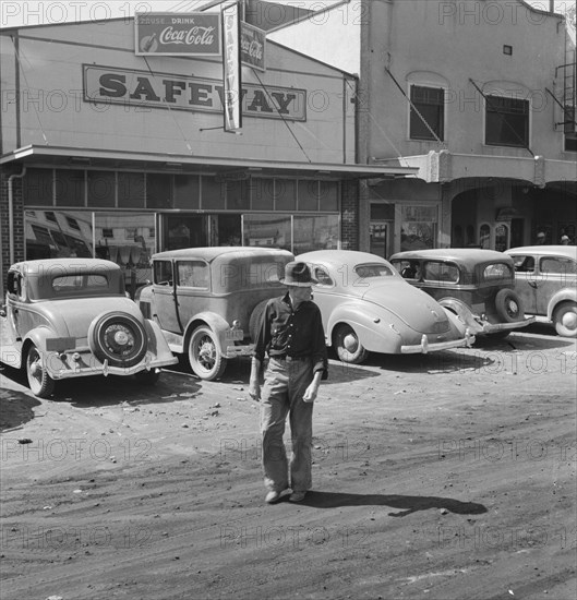 California. Siskiyou County, Tulelake. Main street. [Man outside Safeway store].