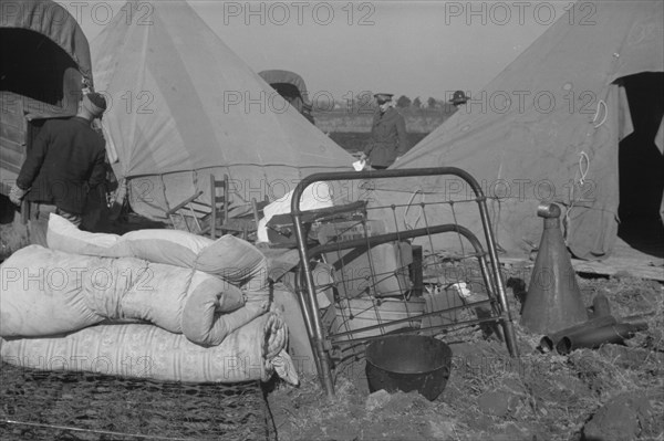 Setting up a tent in the camp for white flood refugees, Forrest City, Arkansas.