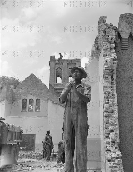 Washington, D.C. Construction workman wrecking a church on Independence Avenue.