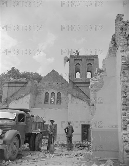 Washington, D.C. Loading debris from wrecked buildings on Independence Avenue.