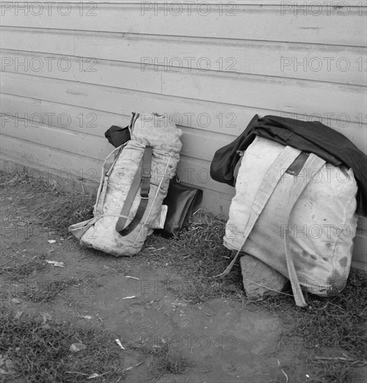 Bindles on shady side of Pastime Cafe. California, Siskiyou County, Tulelake.