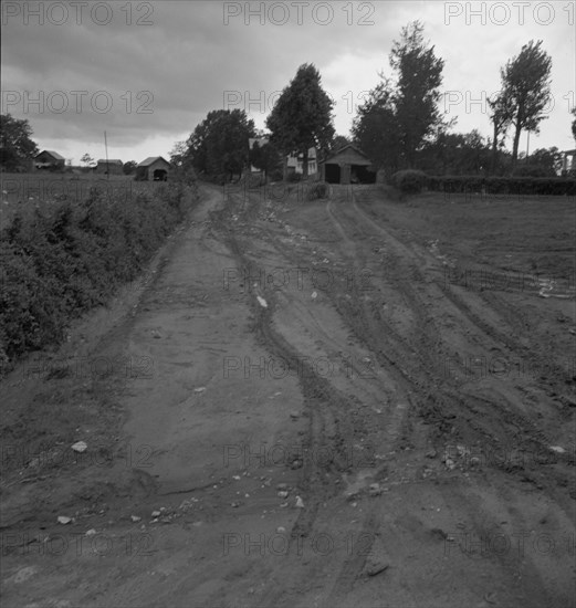 Dirt road. Earth is red-colored clay mud. Granville County, North Carolina.