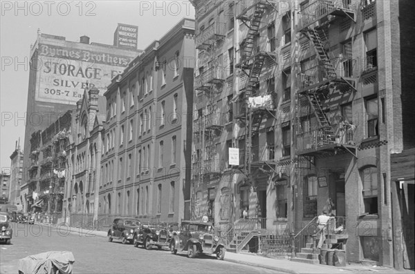 New York, New York. 61st Street between 1st and 3rd Avenues. House fronts.