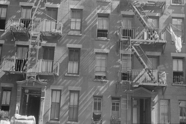 New York, New York. 61st Street between 1st and 3rd Avenues. House fronts.