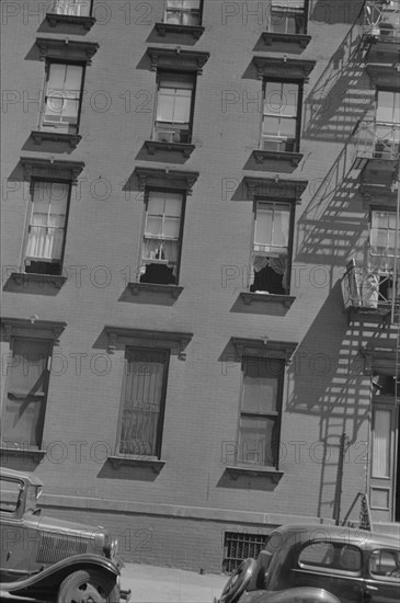 New York, New York. 61st Street between 1st and 3rd Avenues. House fronts.