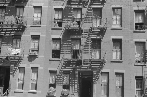 New York, New York. 61st Street between 1st and 3rd Avenues. House fronts.