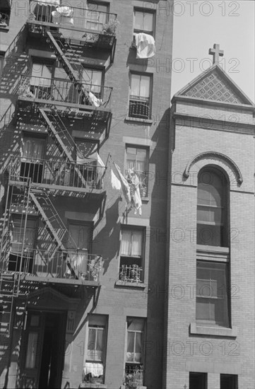 New York, New York. 61st Street between 1st and 3rd Avenues. House fronts.