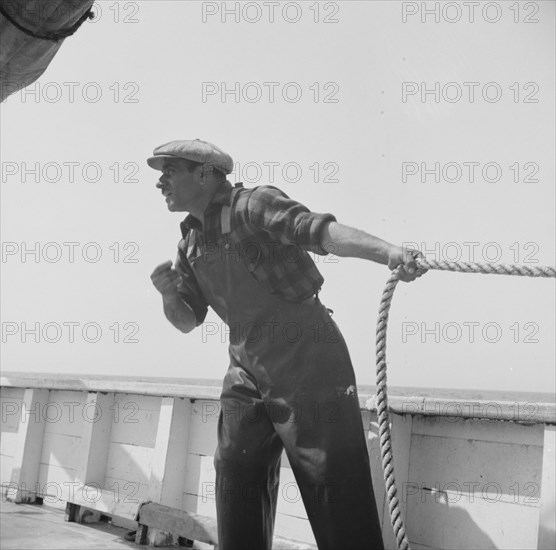 Vito Camella hollers for help to anchor a dory. Glocester, Massachusetts.