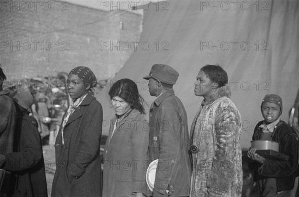 Negroes at mealtime in the flood refugee camp, Forrest City, Arkansas.