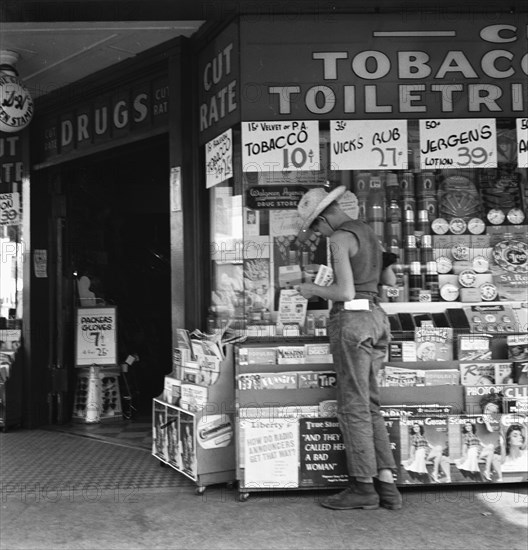 Oregon. Medford. Half-grown farm boy on main drugstore corner in town.