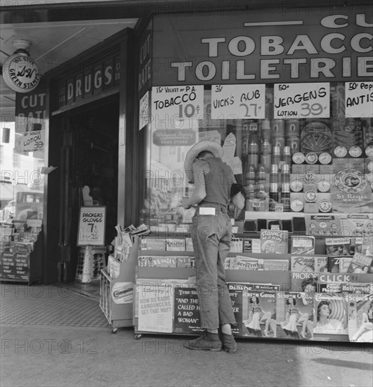 Oregon. Medford. Half-grown farm boy on main drugstore corner in town.