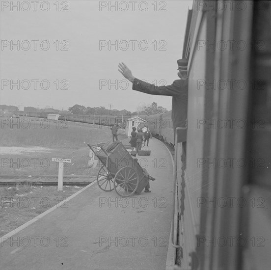 Saint Augustine, Florida. Trainman signalling from a "Jim Crow" coach.