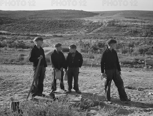 Boys wait for school bus in the morning. Malheur County, Oregon.