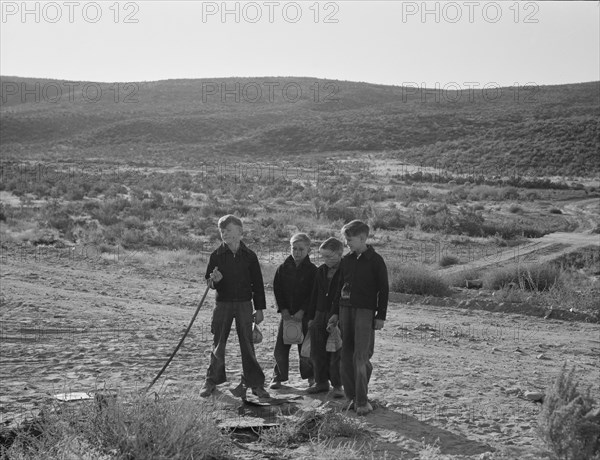 Boys wait for school bus in the morning. Malheur County, Oregon.