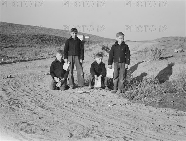 Boys wait for school bus in the morning. Malheur County, Oregon.