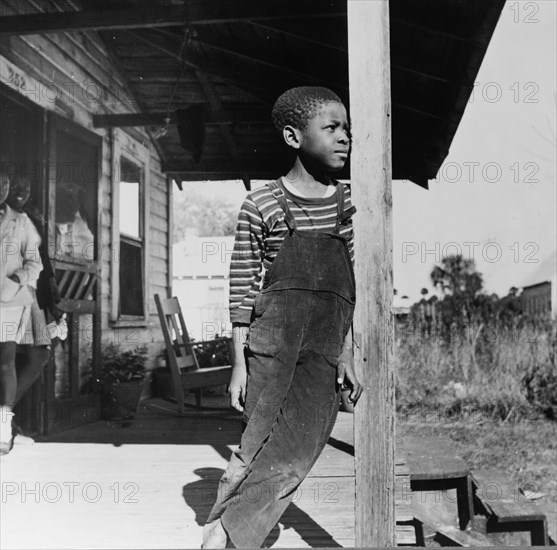 Daytona Beach, Florida. Young boy on his front porch.