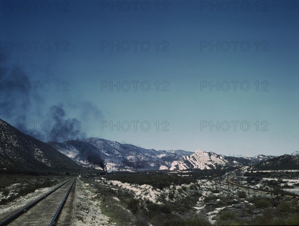 Freight train going up Cajon Pass through the San Bernardino Mountains, Cajon, Calif., 1943. Creator: Jack Delano.
