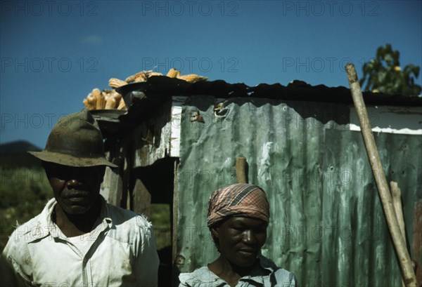 FSA - Tenant Purchase borrower? in front of their house, Puerto Rico, 1941 or 1942. Creator: Jack Delano.