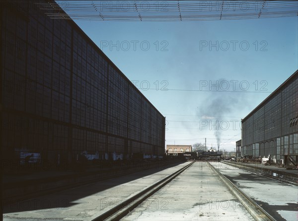 A completely overhauled engine on the transfer table at the Atchison, Topeka..., New Mexico., 1943. Creator: Jack Delano.