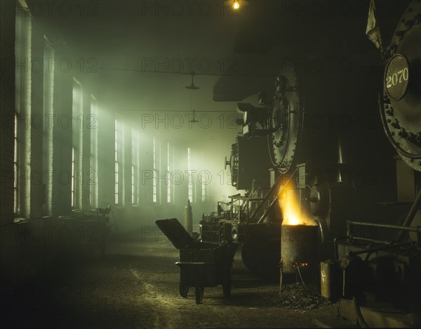 In the roundhouse at a Chicago and North Western Railroad yard, Chicago, Ill., 1942. Creator: Jack Delano.