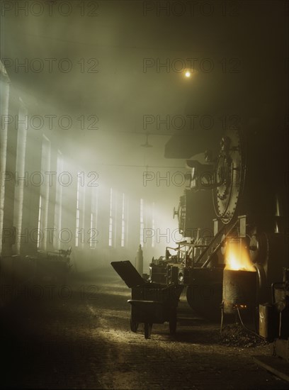 In the roundhouse at a Chicago and North Western Railroad yard, Chicago, Ill., 1942. Creator: Jack Delano.