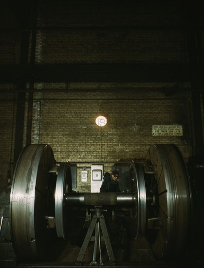 Worn tires on locomotive wheels are refaced on this machine in the wheel shop..., Chicago, 1942. Creator: Jack Delano.