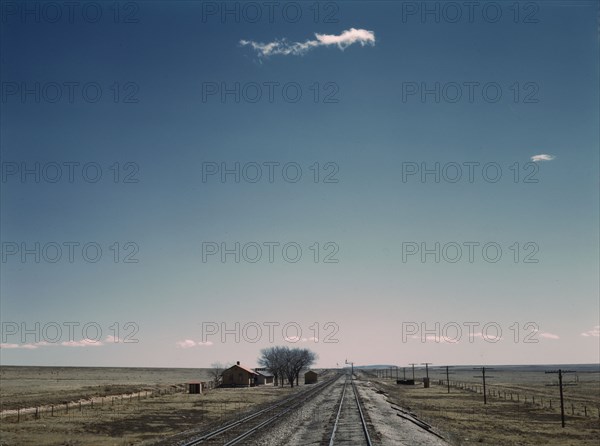 Passing a section house along the Atchison, Topeka, and Santa Fe railroad, New Mexico, 1943. Creator: Jack Delano.