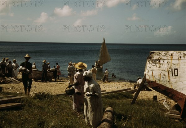 Housewives at the seashore waiting for the fishing boats to come in Frederiksted, V.I., 1941. Creator: Jack Delano.