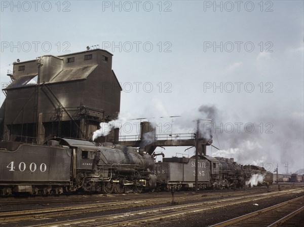 Servicing engines at coal and sand chutes at Argentine yard, Santa Fe R.R., Kansas City, 1943. Creator: Jack Delano.