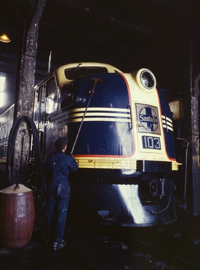 Washing one of the Santa Fe R.R. 54 hundred horse power diesel freight...,Argentine, Kansas, 1943. Creator: Jack Delano.