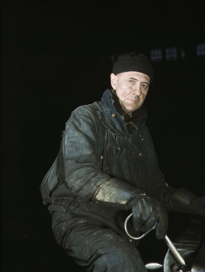 A worker in the roundhouse at the C & NW RR., Proviso yard, Chicago, Ill., 1942. Creator: Jack Delano.