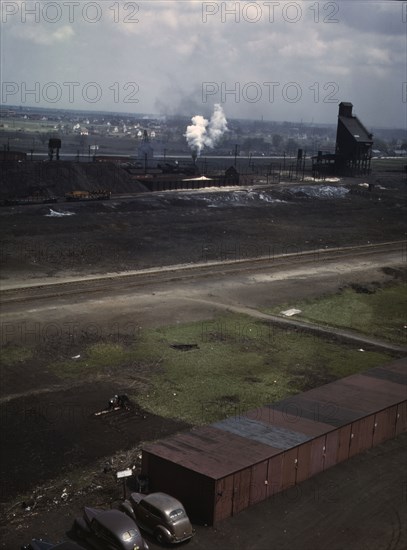 C & NW RR railroad worker cultivating the small Victory garden, Proviso yard, Chicago, Ill., 1943. Creator: Jack Delano.