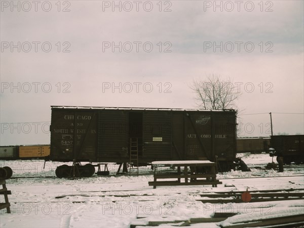 Car jacked up for repairs on the repair tracks, North Proviso, C & NW RR, Chicago, Ill., 1942. Creator: Jack Delano.