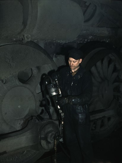 Greasing a locomotive in the roundhouse at Proviso (?) yard, C & NW RR, Chicago, Ill., 1942. Creator: Jack Delano.