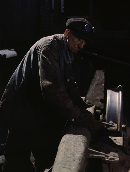 Sam Cell, working on the truck of a car..., C & NW RR's Proviso yard, Chicago, Ill., 1943. Creator: Jack Delano.