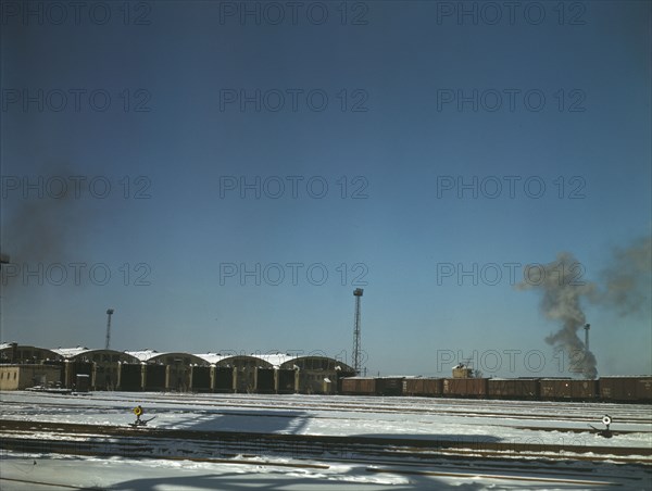 Train pulling out of the freight house at C & NW RR's Proviso Yard, Chicago, Ill., 1942. Creator: Jack Delano.