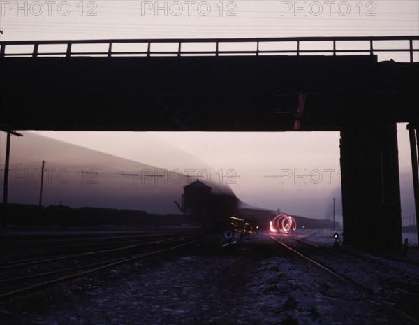 View in a departure yard at C & NW RR's Proviso (?) yard at twilight, Chicago, Ill., 1942. Creator: Jack Delano.