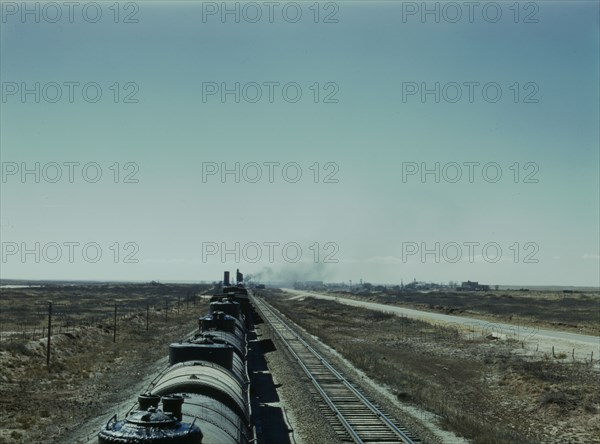 West bound Santa Fe R.R. freight train stopping for water, Tolar, New Mexico, 1943. Creator: Jack Delano.