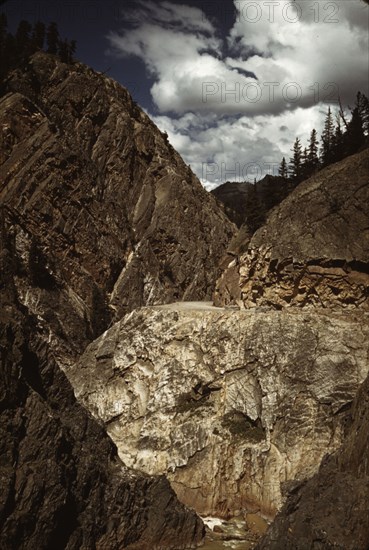 Million dollar highway [U.S. 550] is cut through massive rocks in Ouray County, Colorado, 1940. Creator: Russell Lee.