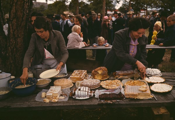 Cutting the pies and cakes at the barbeque dinner, Pie Town, New Mexico Fair, 1940. Creator: Russell Lee.