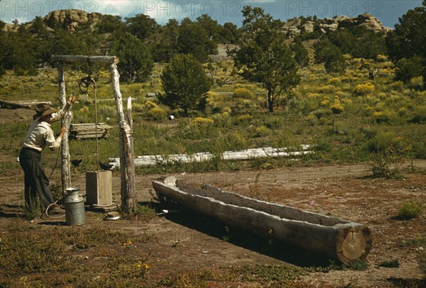 Faro Caudill drawing water from his well, Pie Town, New Mexico, 1940. Creator: Russell Lee.