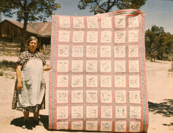 Mrs. Bill Stagg with state quilt that she made, Pie Town, New Mexico. , 1940. Creator: Russell Lee.