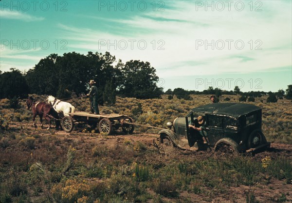 Team pulling a car out of the mud; the roads near Pie Town, New Mexico are not improved, 1940. Creator: Russell Lee.
