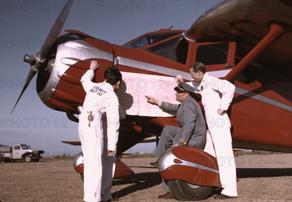 Instructor and students studying a map, Meacham Field, Fort Worth, Tex., 1942. Creator: Arthur Rothstein.