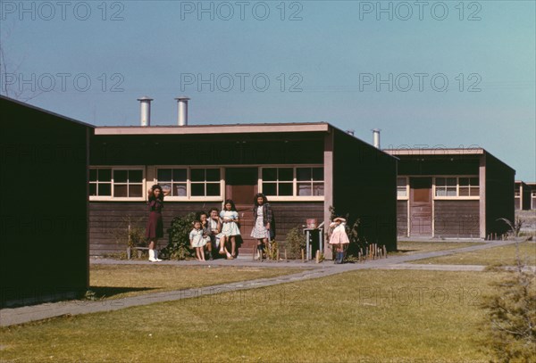 Families of migratory workers in front of their row shelters, FSA ...camp, Robstown, Tex., 1942. Creator: Arthur Rothstein.