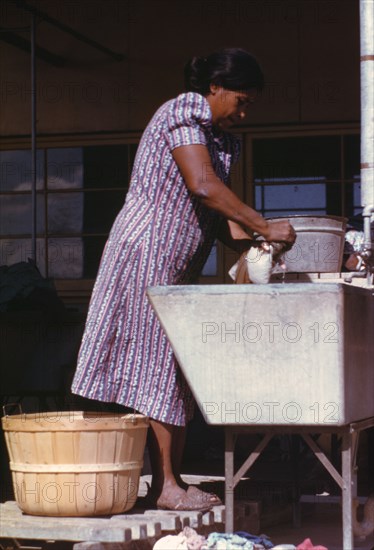 Woman at the community laundry on Saturday afternoon, FSA ... camp, Robstown, Tex., 1942. Creator: Arthur Rothstein.