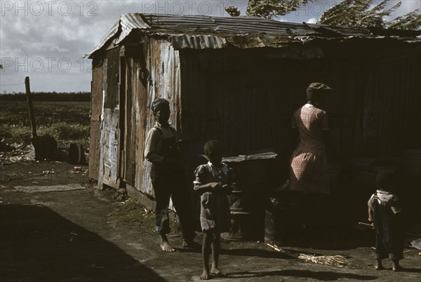 Negro migratory workers by a shack, Belle Glade, Fla., 1941. Creator: Marion Post Wolcott.