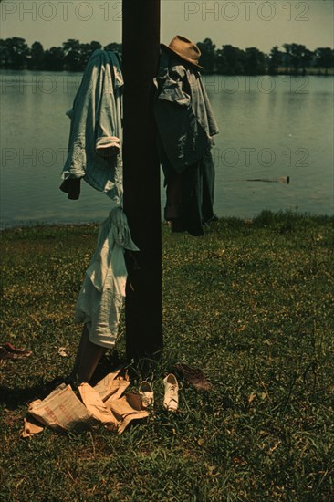 Clothes of swimmers hanging on a telegraph pole, Lake Providence, La., 1940. Creator: Marion Post Wolcott.